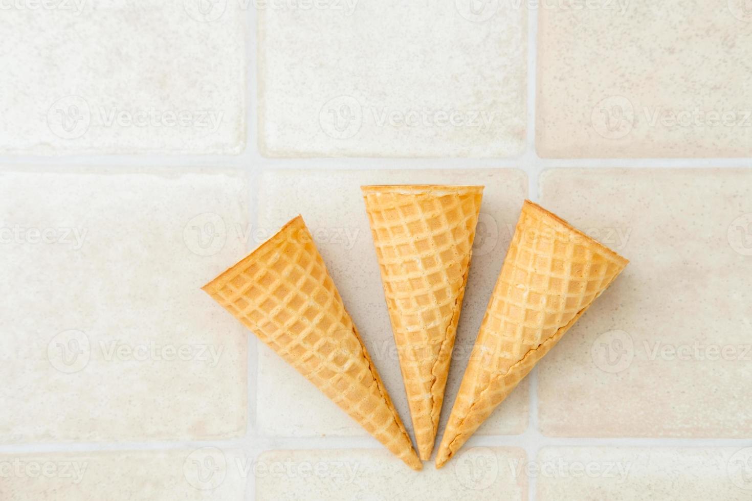 three empty ice cream waffle cones on a white background, top view photo