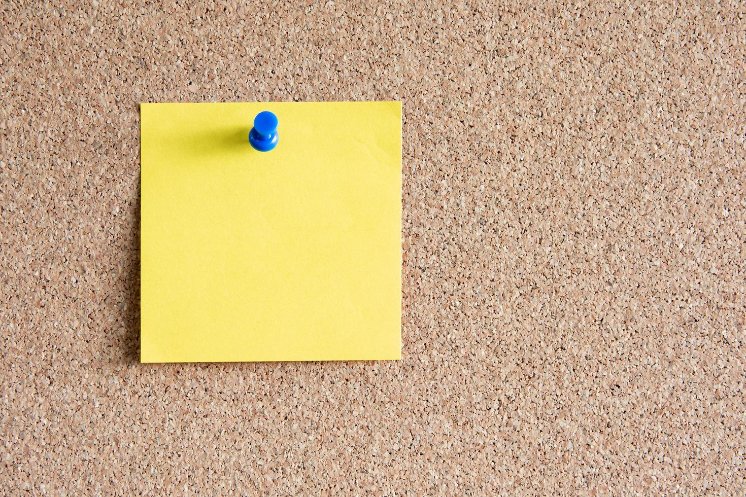 Blank paper note with pin on board. With copy space for ideas, reminders, appointments, to-do lists, messages. photo