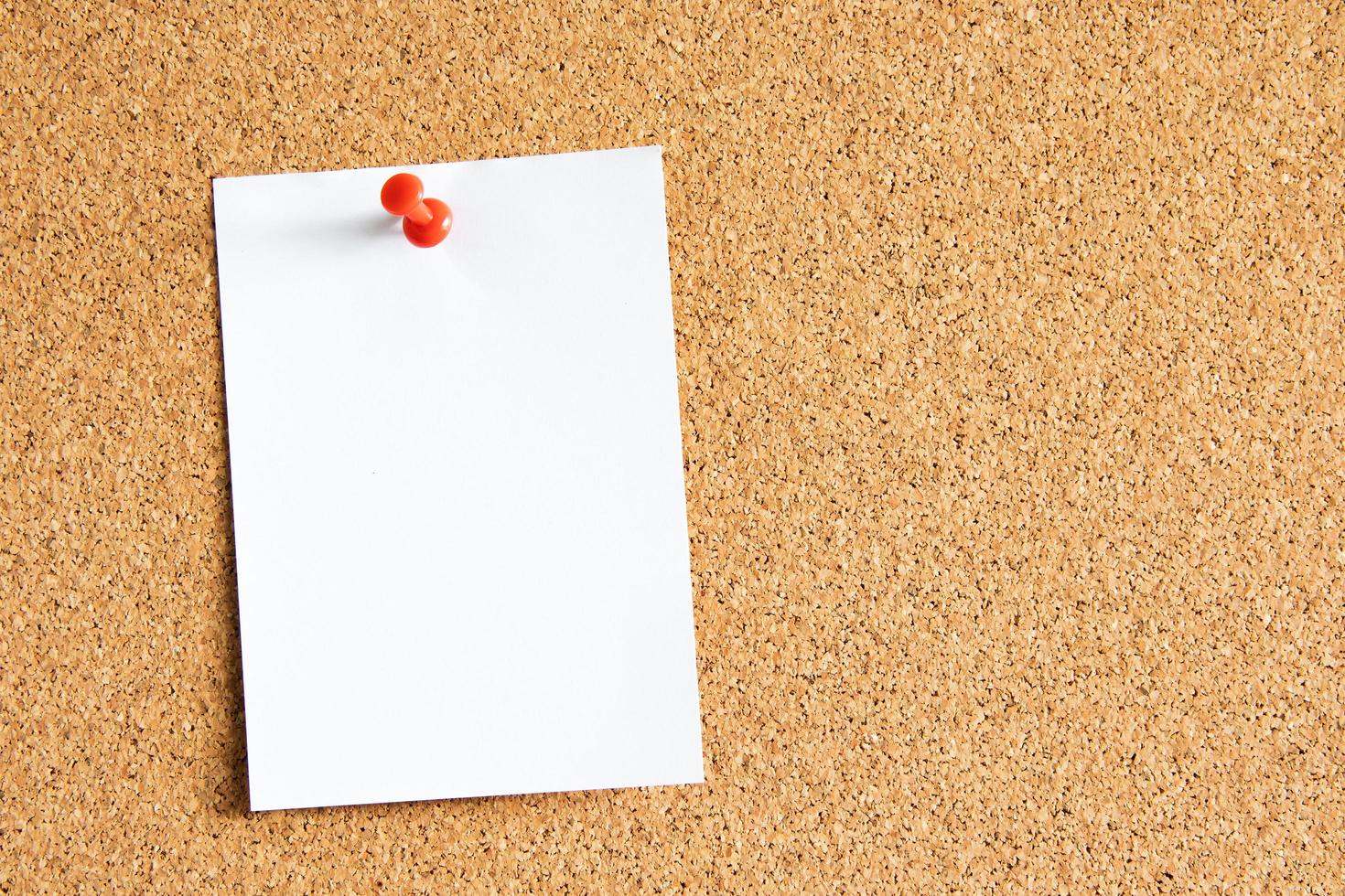 Blank paper note with pin on board. With copy space for ideas, reminders, appointments, to-do lists, messages. photo