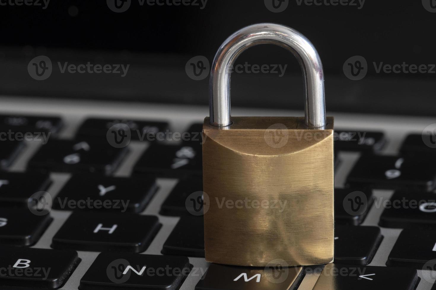 internet and computer security represented by a closed padlock over a black keyboard photo