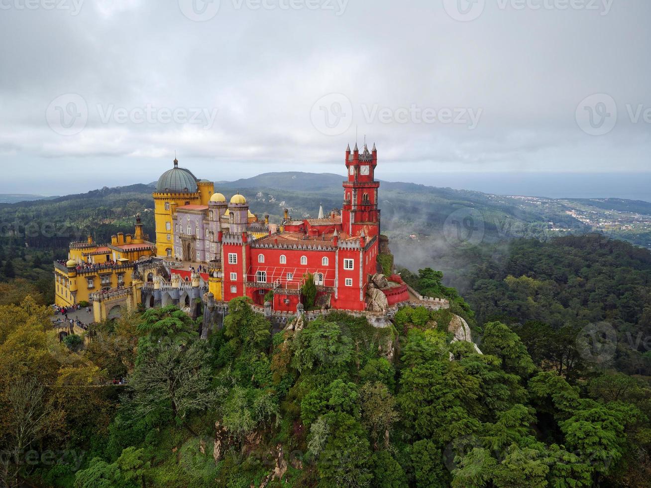 Aerial drone view of Park and National Palace of Pena in Sintra, Portugal during a magical day. Unesco. Historic visits. Sightseeing. Fairytale. Best destinations in the world. Most visited places. photo