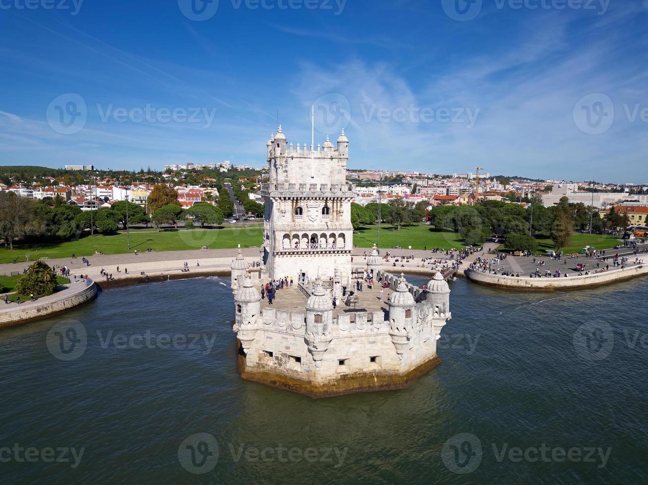 Aerial drone view of Belem Tower in Lisbon, Portugal during a beautiful sunny day next to the river Tagus. Unesco World Heritage. Historic visits. Holidays and summer vacation tourism. Colorful palace photo