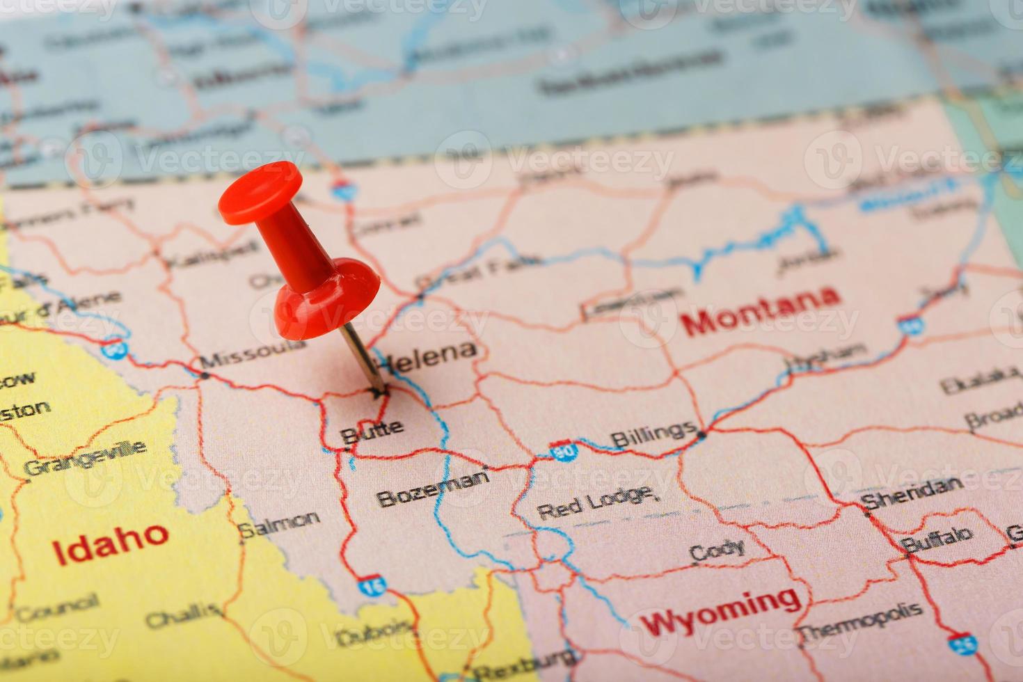 Red clerical needle on a map of USA, Montana and the capital of Helena. Close up Montana map with red tack photo