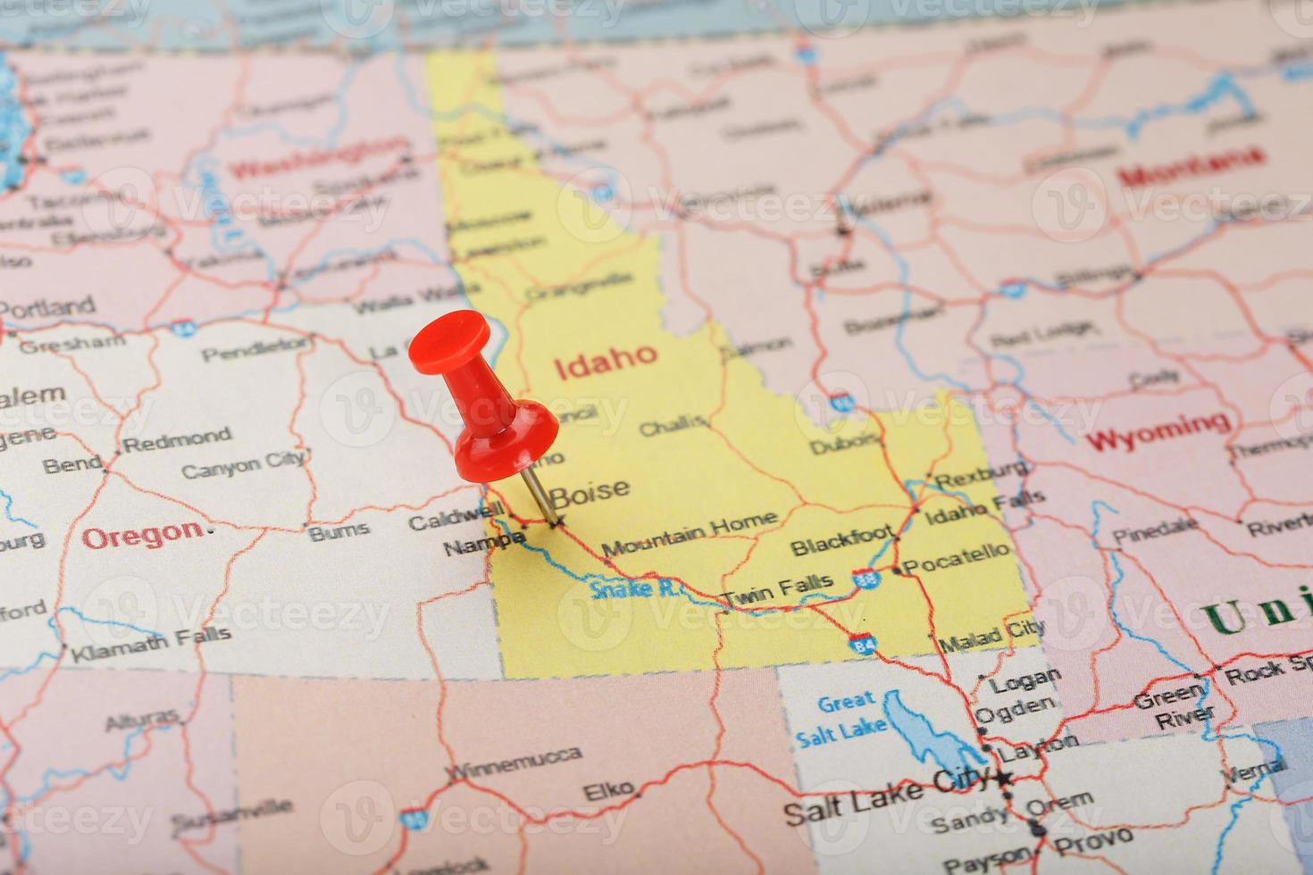 Red clerical needle on a map of USA, Idaho and the capital Boise. Closeup Map Idaho with Red Tack photo