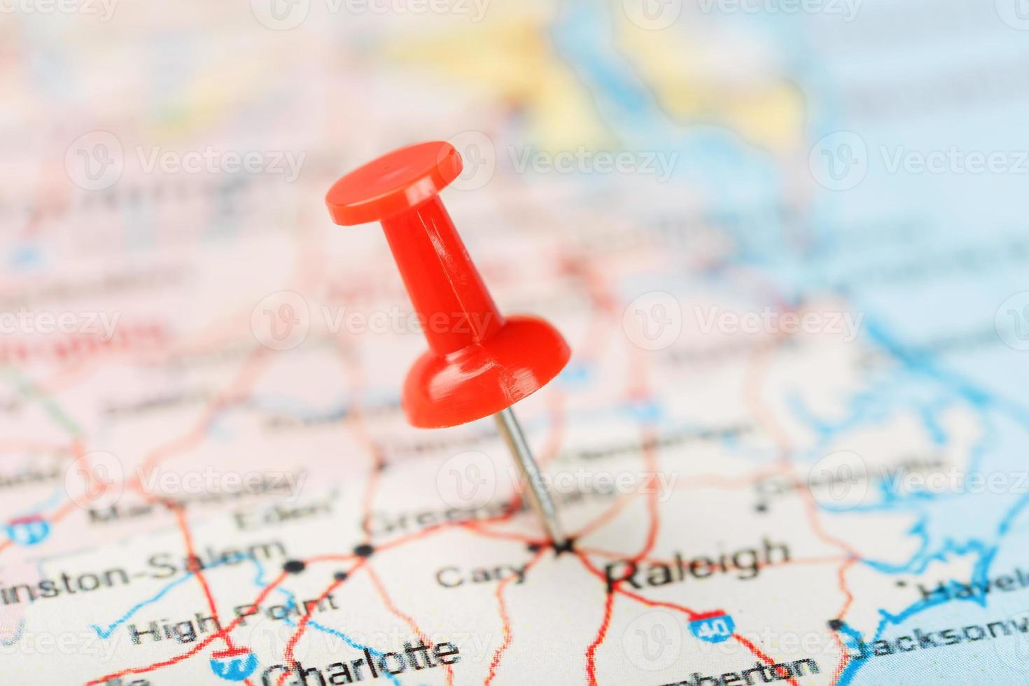 Red clerical needle on a map of USA, South North Carolina and the capital Raleigh. Close up map of South North Carolina with red tack, United States map pin photo