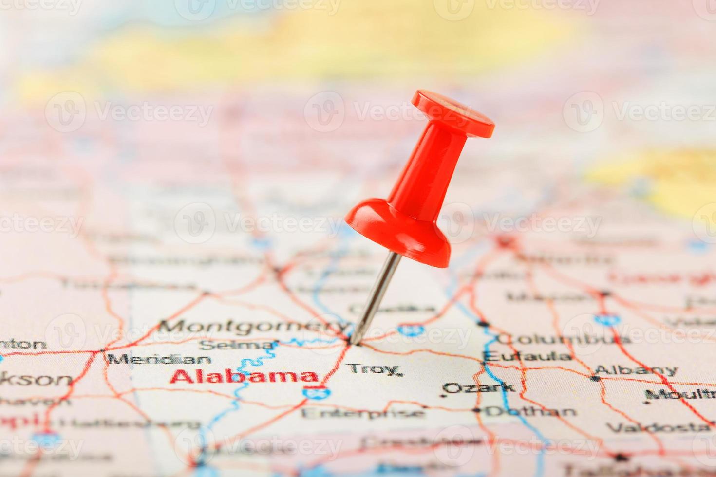 Red clerical needle on a map of USA, South Alabama and the capital Montgomery. Close up map of South Alabama with red tack photo