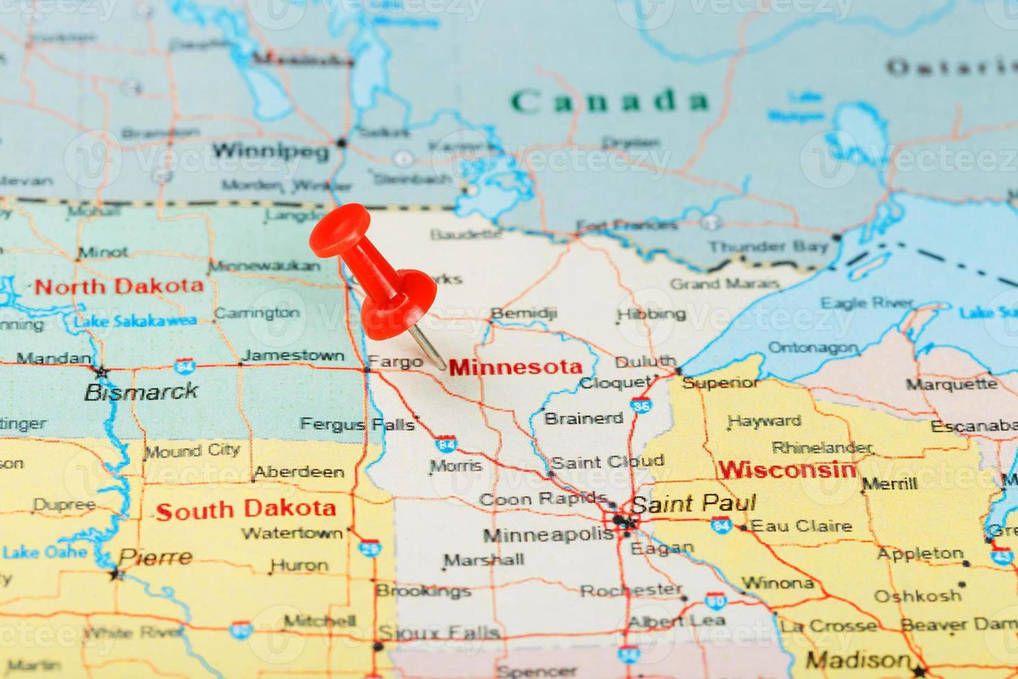 Red clerical needle on a map of USA, Minnesota and the capital Saint Paul. Close up map of Minnesota with red tack photo