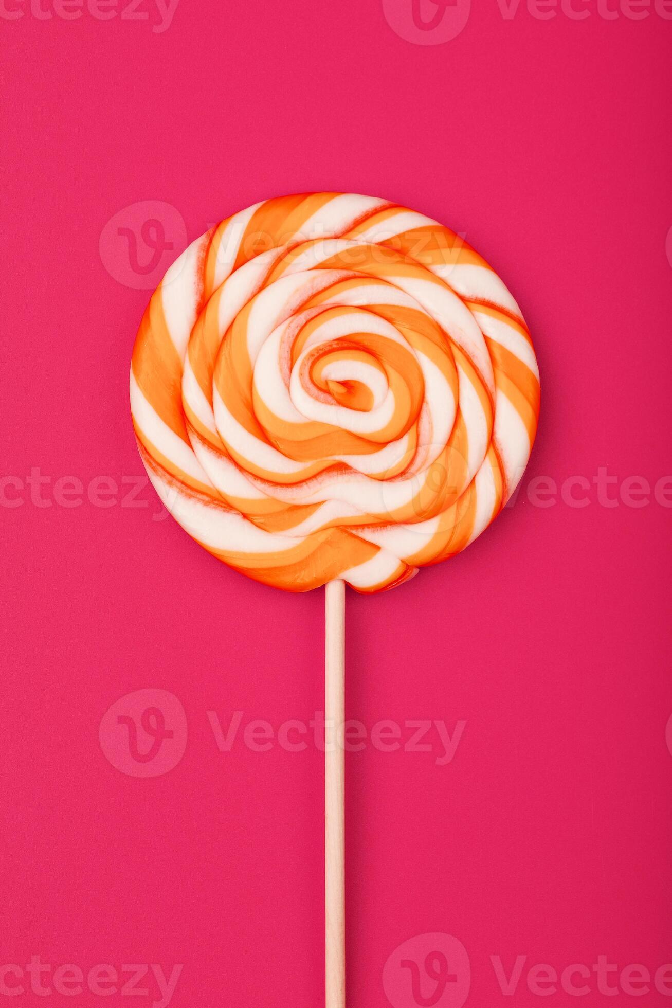 A large yellow Lollipop, on a scarlet background. Minimal concept with