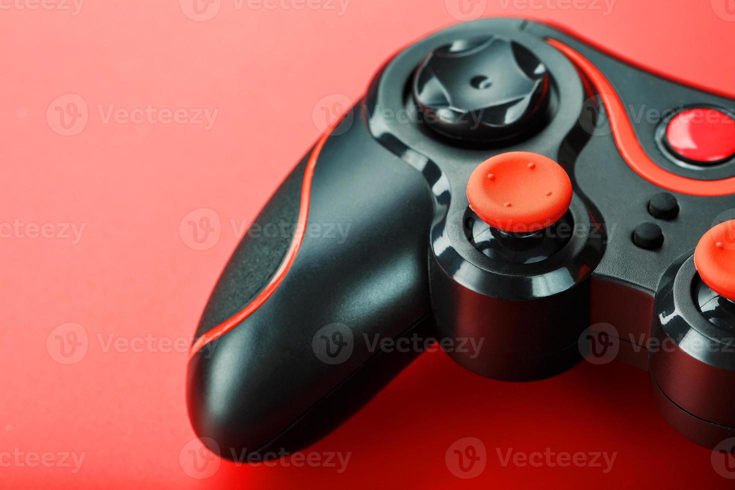 Game controller controller on red background. Device to control and control the game. close up photo