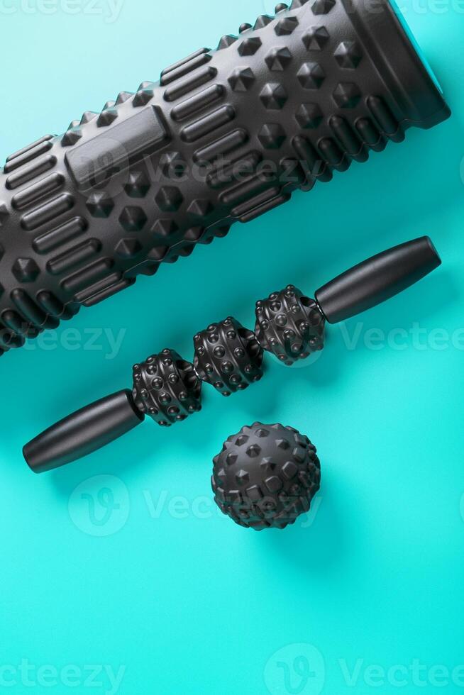 A set of black bumpy foam massage rollers, body rollers, rubber balls