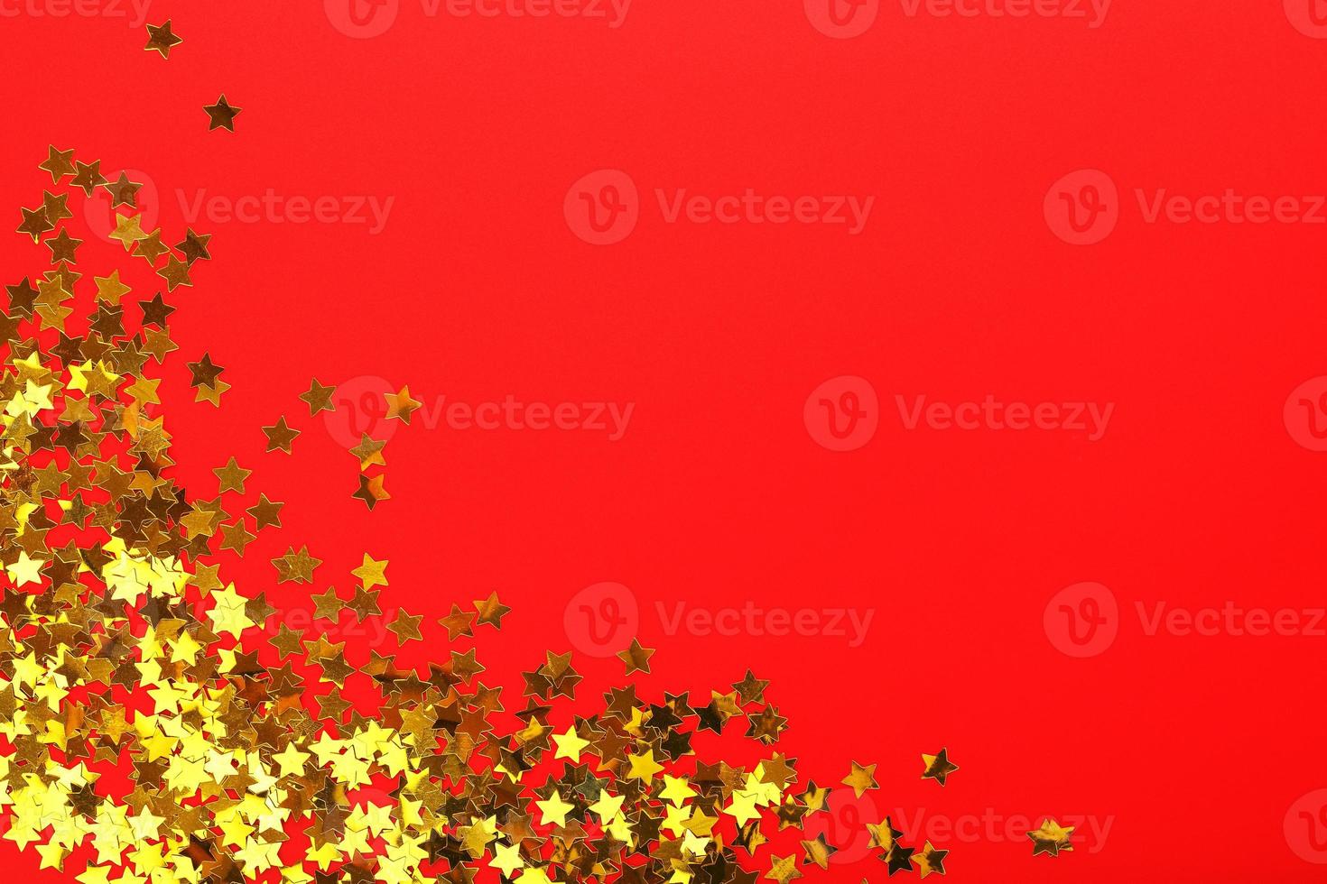 Gold stars on red background. The concept of greeting cards, headlines and web site. A scattering of Golden stars photo