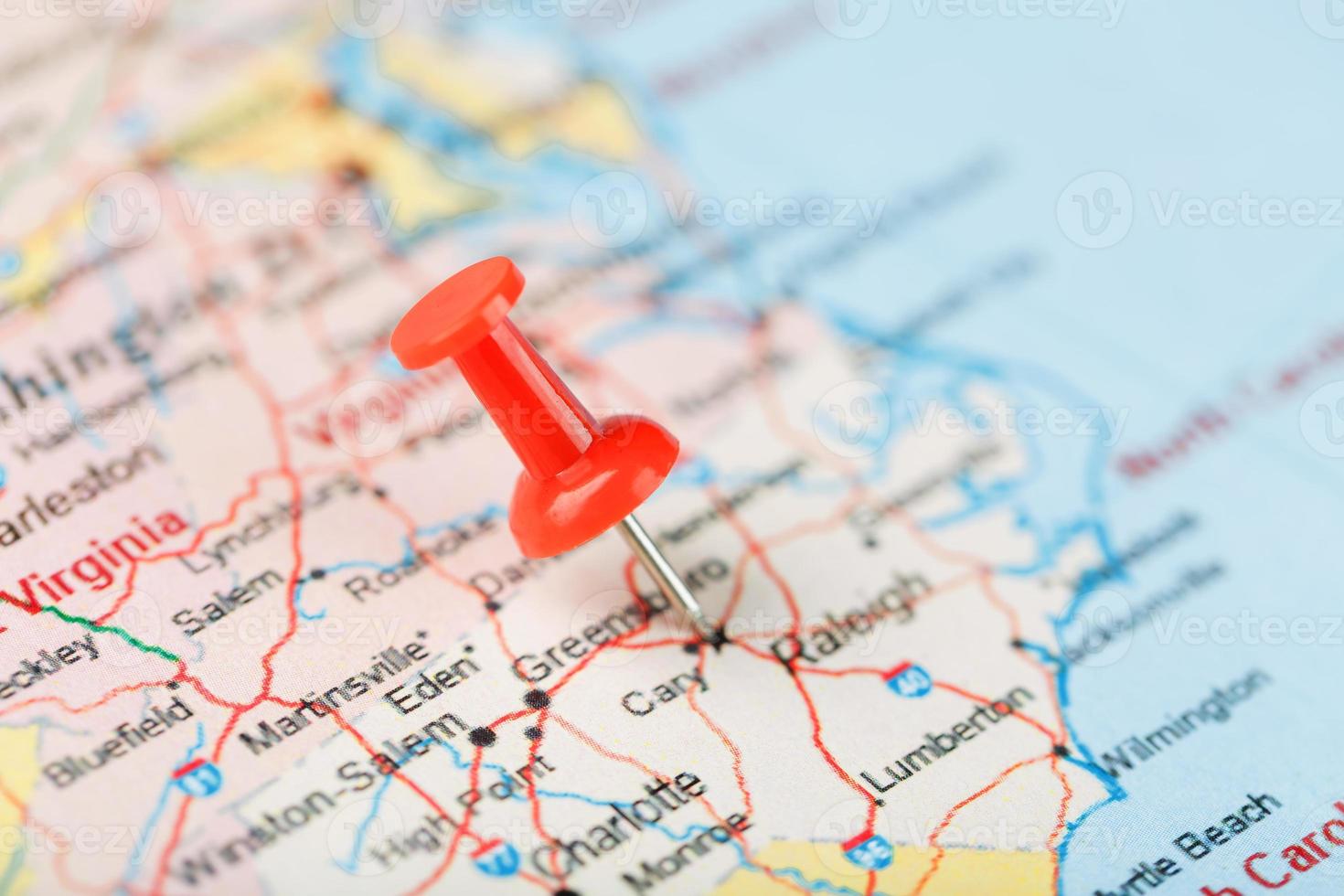 Red clerical needle on a map of USA, South North Carolina and the capital Raleigh. Close up map of South North Carolina with red tack, United States map pin photo