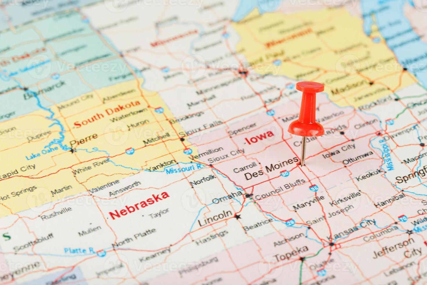 Red clerical needle on a map of USA, Iowa and the capital Des Moines. Close up map of Iowa with red tack photo