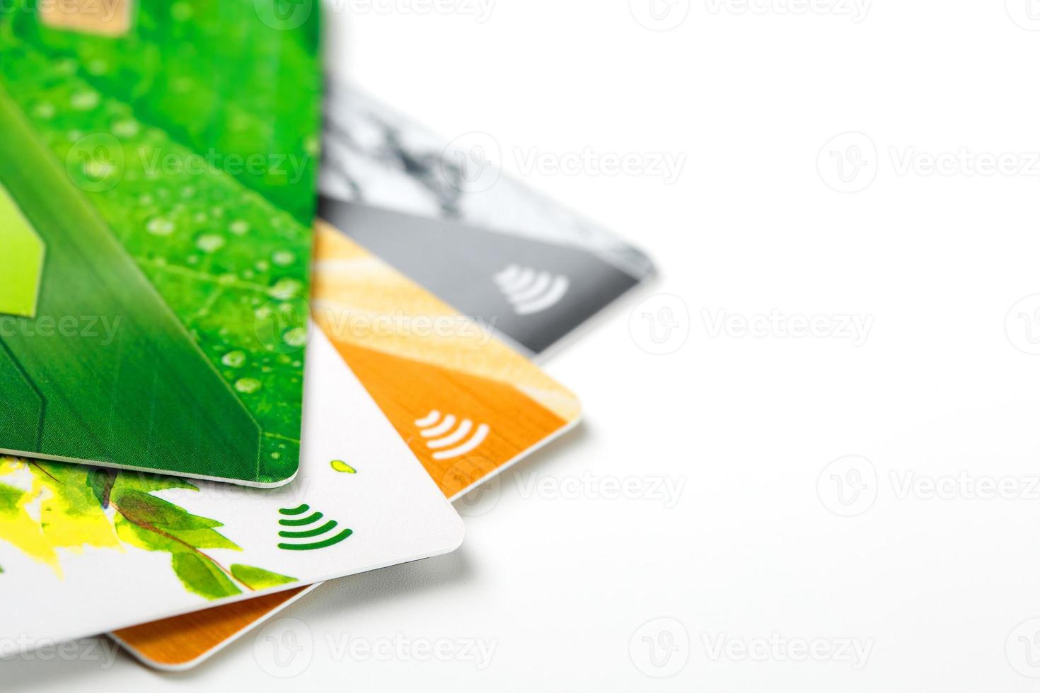 Credit cards with contactless payment. Pile of credit cards on white isolated background photo