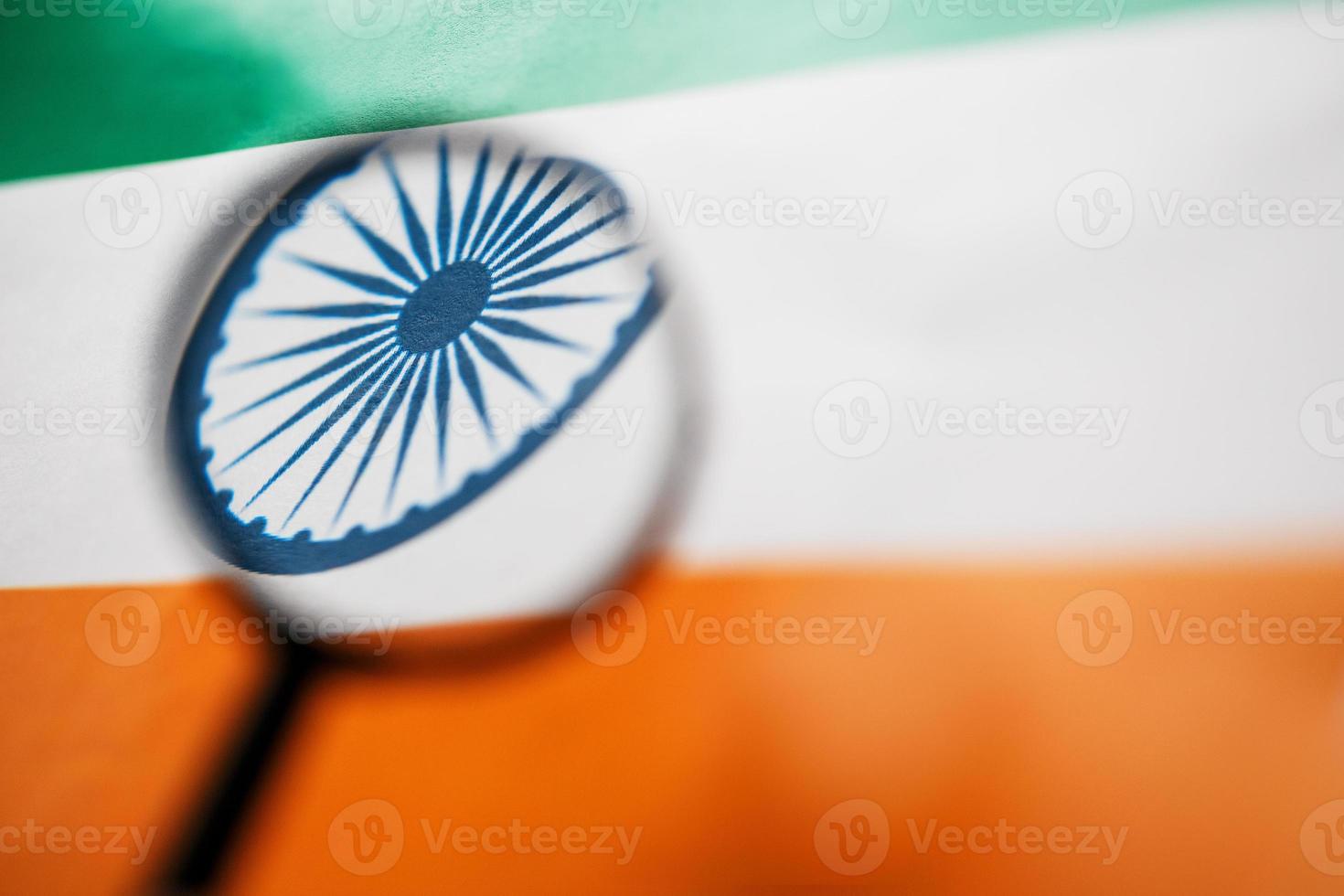 Learning Indian language concept. Young woman standing with the India flag in the background. Teacher holding books, orange blank book cover photo