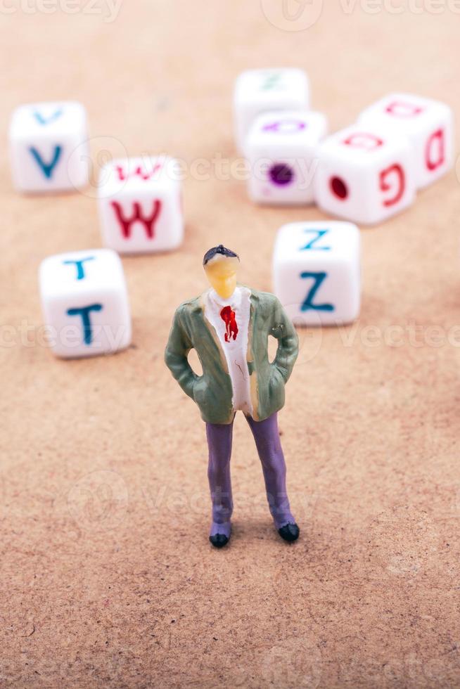 Figurine and the colorful alphabet letter cubes photo