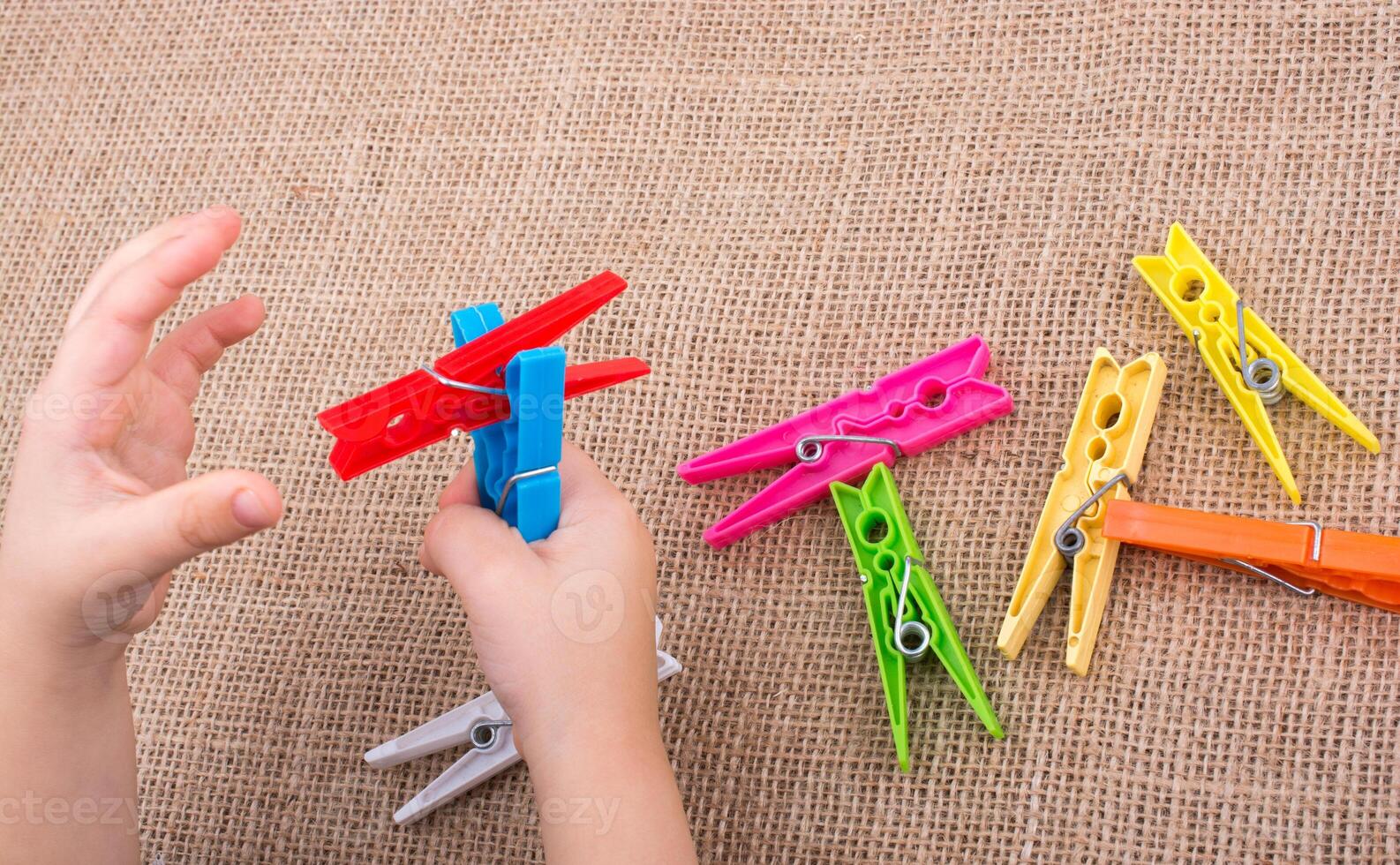 Clothespin in hand on a linen canvas background 14552251 Stock Photo at Vecteezy