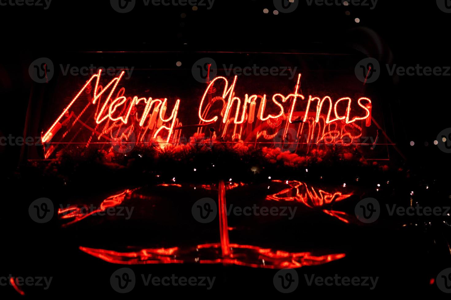 led red Christmas decoration and ornaments over abstract bokeh background with copy space. Holiday background greeting card for Christmas and New Year. Merry Christmas photo