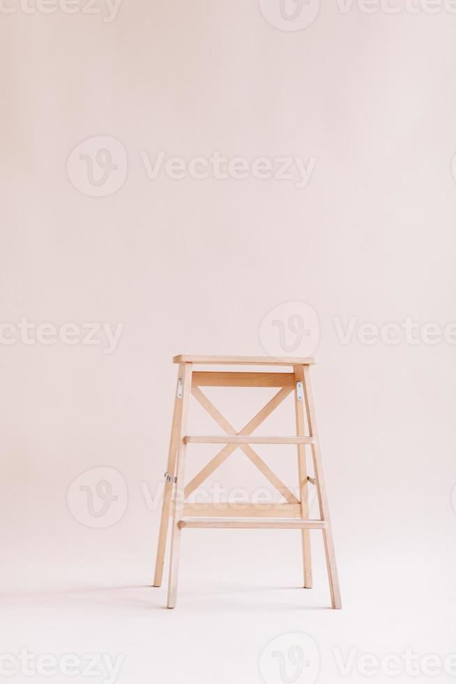 New wooden ladder on the white background. isolated stepladder. Space for text photo