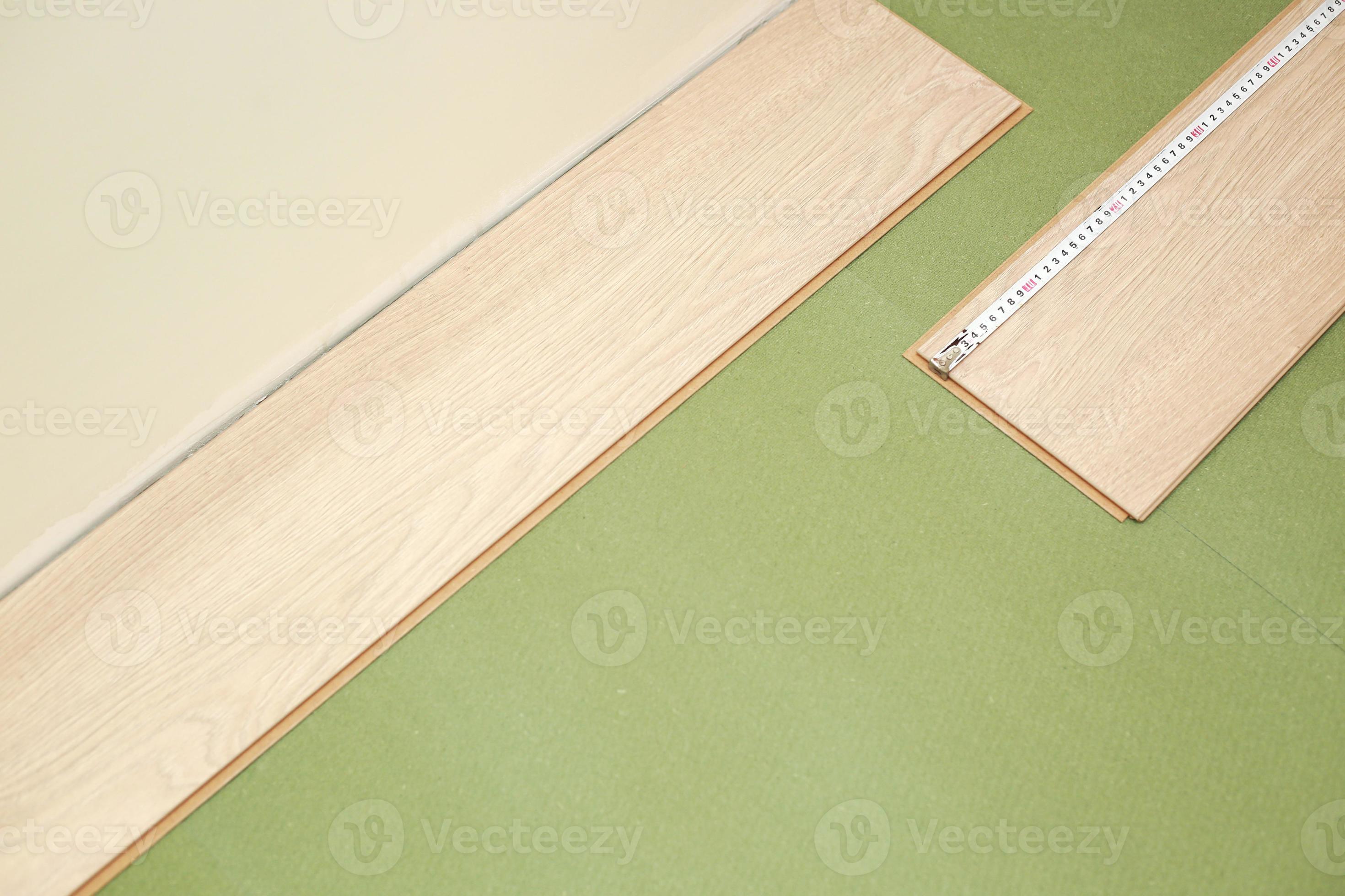 Installation laminate or parquet in the room, worker installing wooden