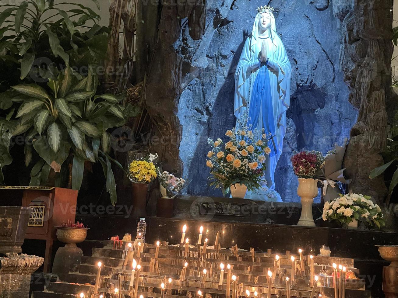 the cave of virgin mary, Statue of Virgin Mary in a rock cave chapel Catholic Church with tropical vegetation photo