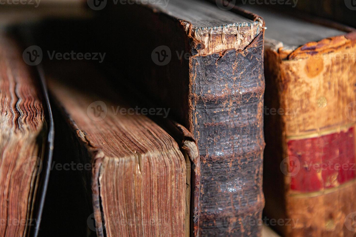 Very old books sitting on the shelves in the library. Books as a symbol of knowledge. photo