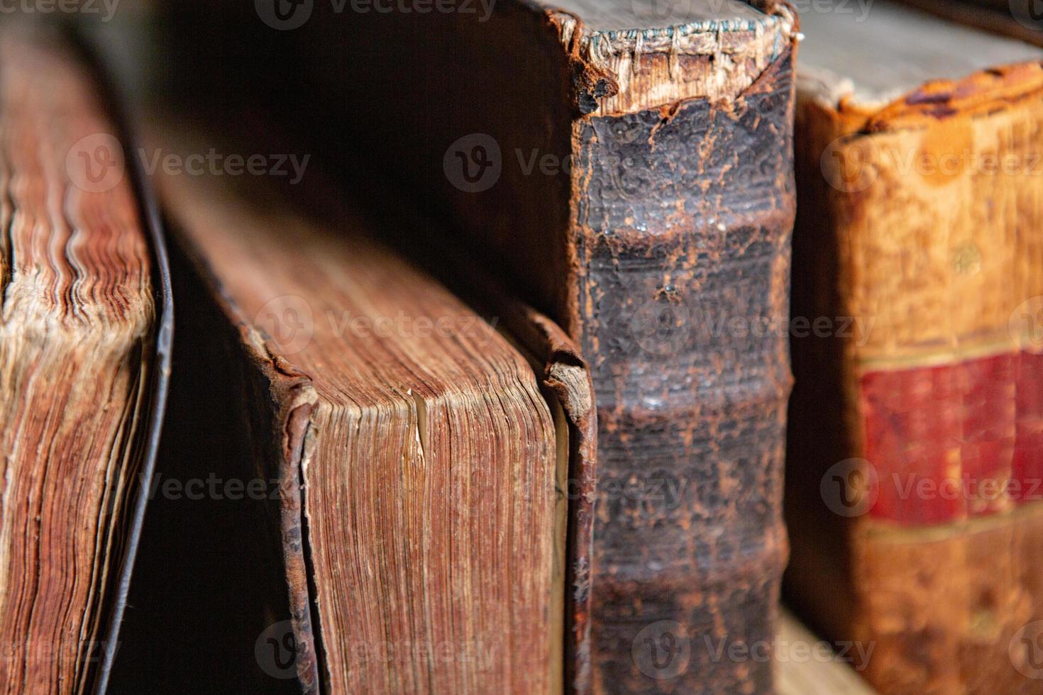 Very old books sitting on the shelves in the library. Books as a symbol of knowledge. photo