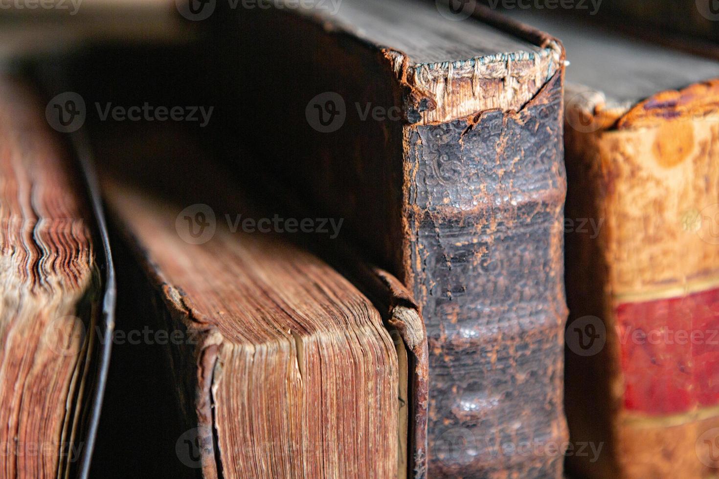 Very old books sitting on the shelves in the library. Books as a symbol of knowledge. photo