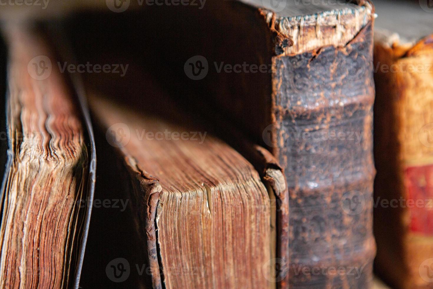 Very old books sitting on the shelves in the library. Books as a symbol of knowledge. photo