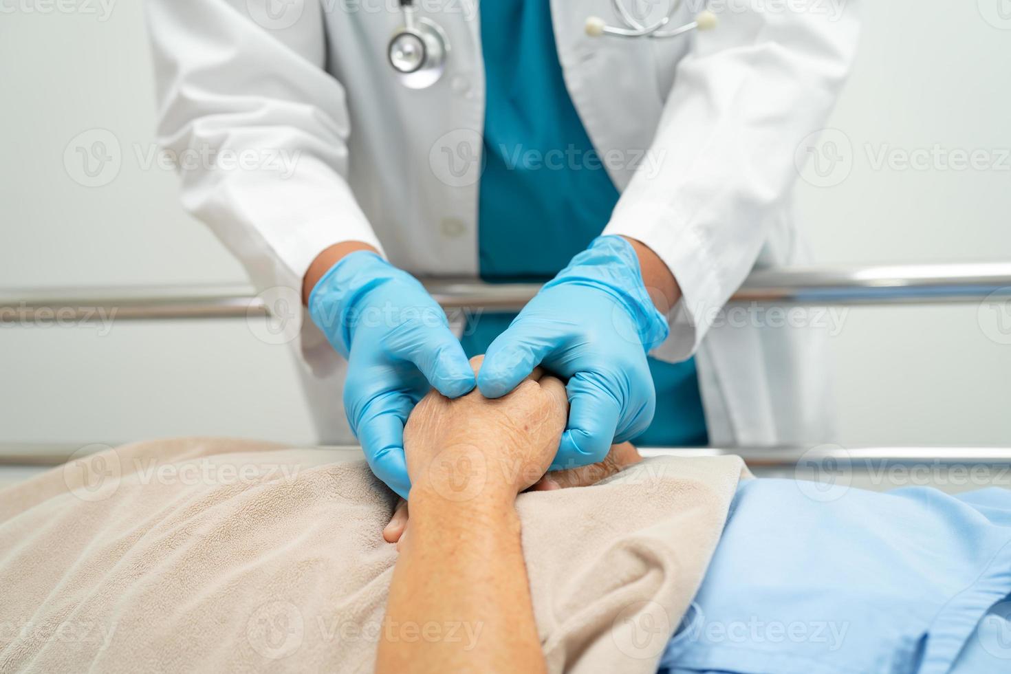 Holding hands Asian senior or elderly old lady woman patient with love, care, encourage and empathy at nursing hospital ward, healthy strong medical concept photo