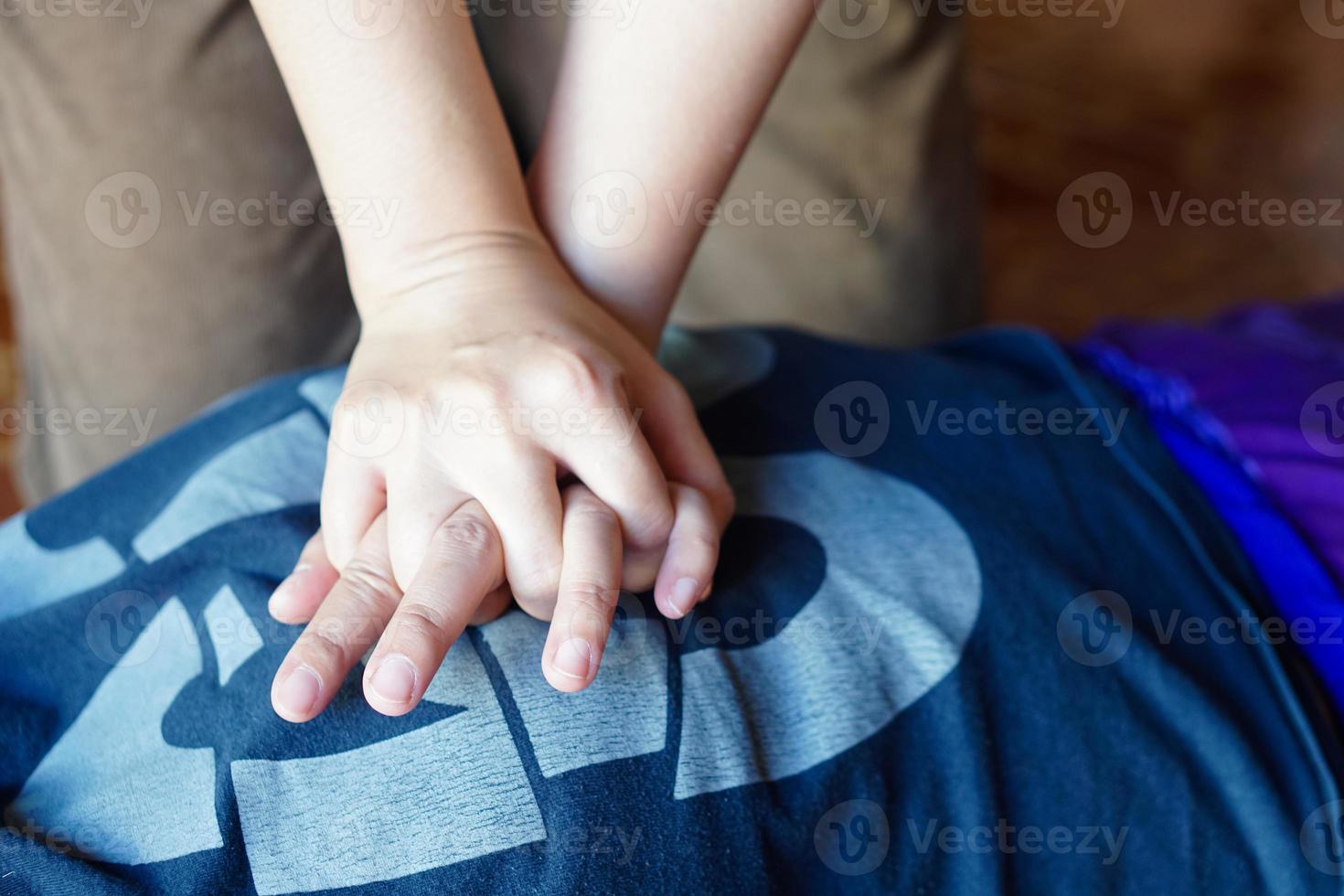 Closeup hand do first aid emergency CPR on heart attack patient.Concept , Heath care, life rescuse. CPR Cardiopulmonary Resuscitation. Heart pumping for unconscious person. photo