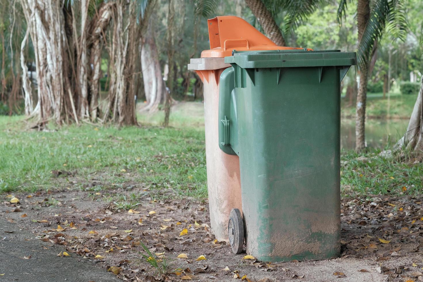 Old and weathered two recycle bin in public park area, copy space. photo