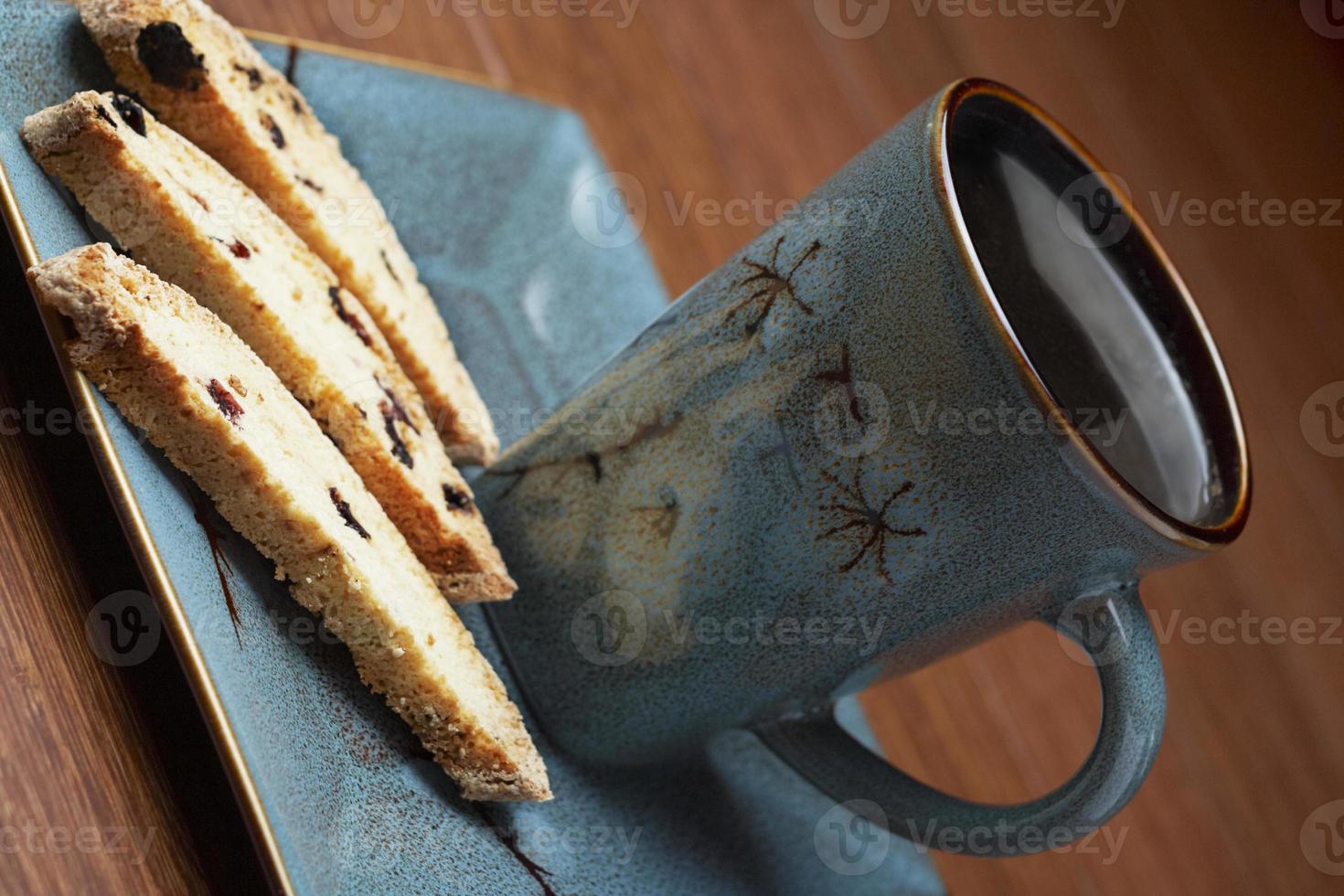 a cup of coffee with biscotti photo
