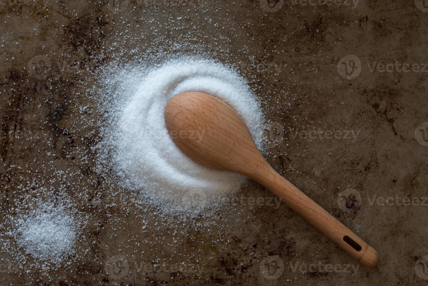 Iodized Table Salt Spilled from a Teaspoon photo