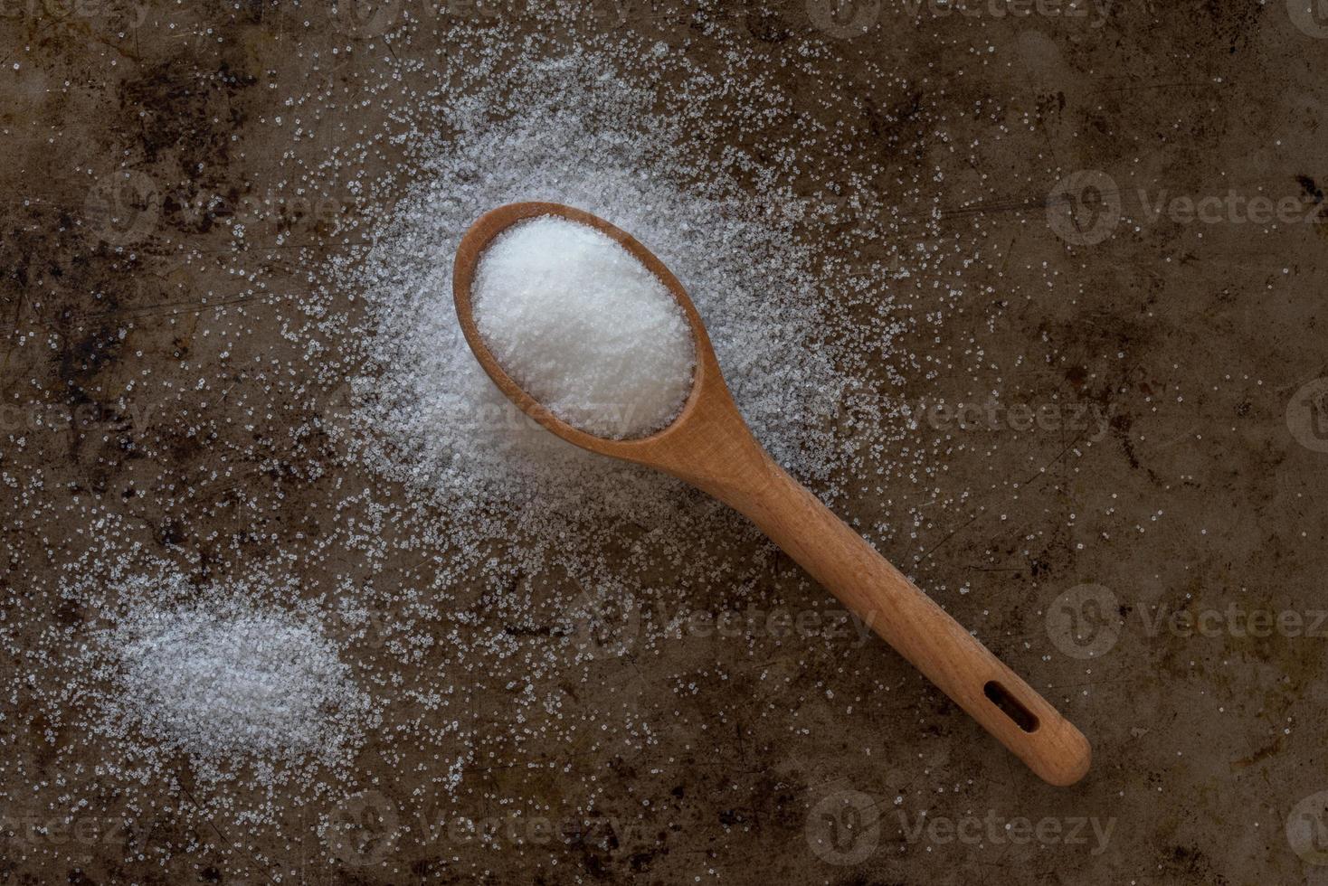 Iodized Table Salt Spilled from a Teaspoon photo