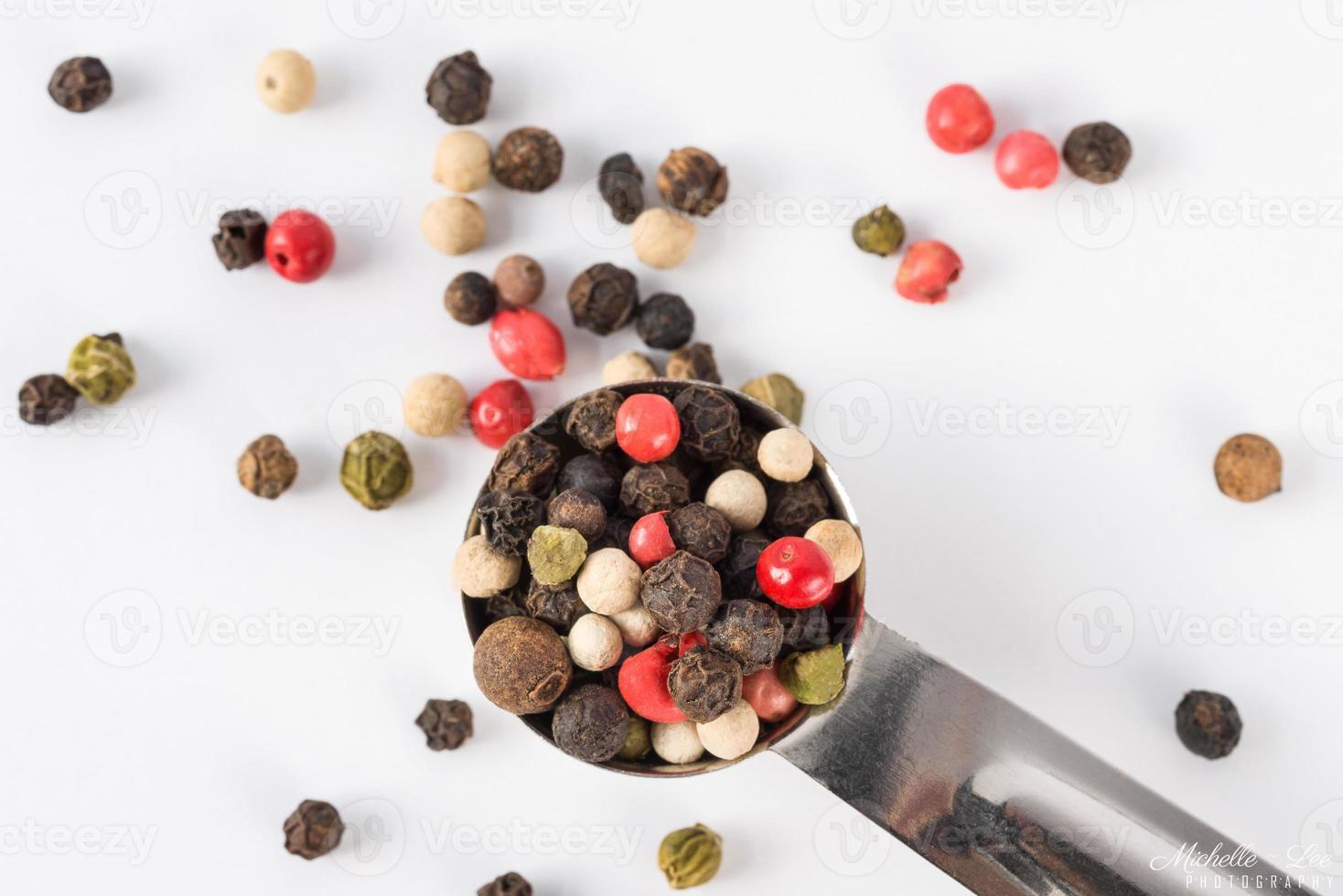 Multi Colored Peppercorns Spilled from a Teaspoon 14557399 Stock Photo