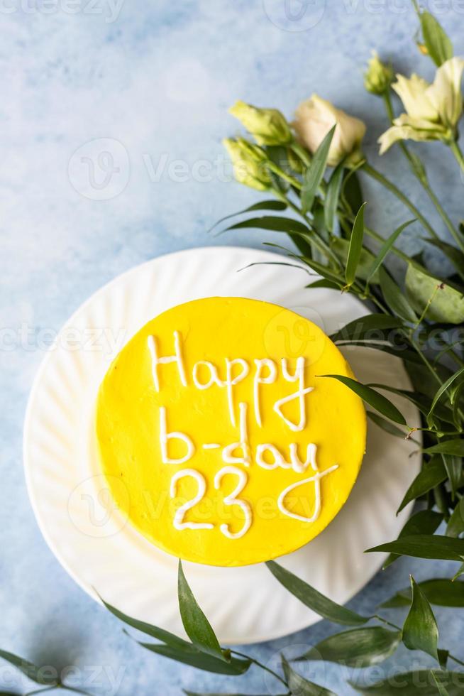 Small bento cake with inscription Happy b-day 23 as gift for the birthday. Korean style cake for one person. A sweet surprise dessert for a loved one. photo