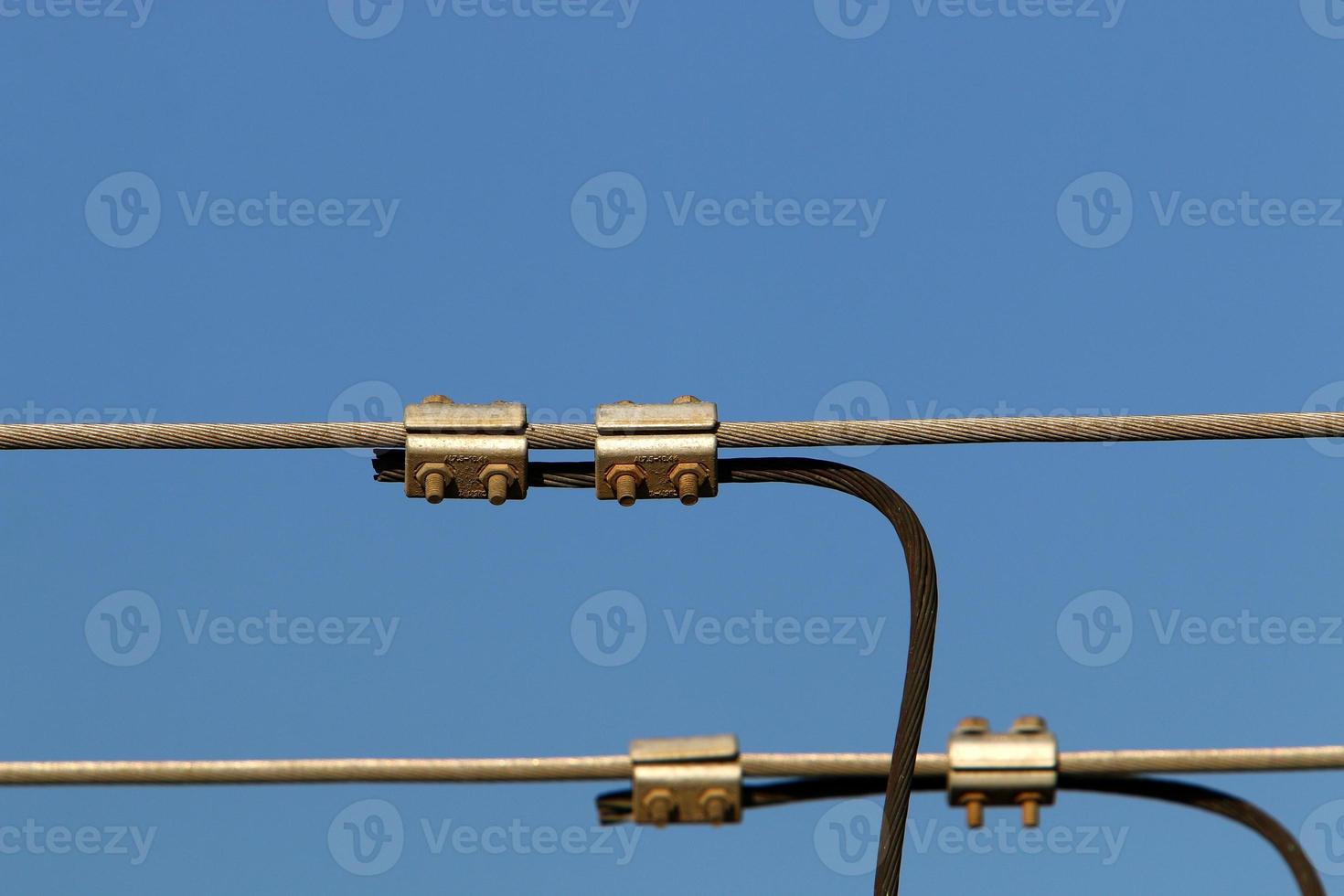 Wires on a pole carrying high voltage electric current. photo