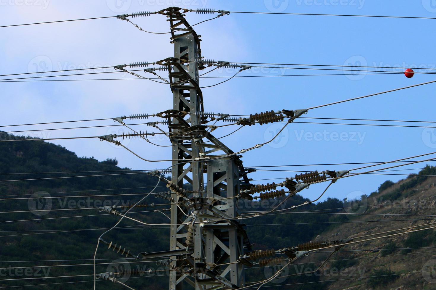 Wires on a pole carrying high voltage electric current. photo