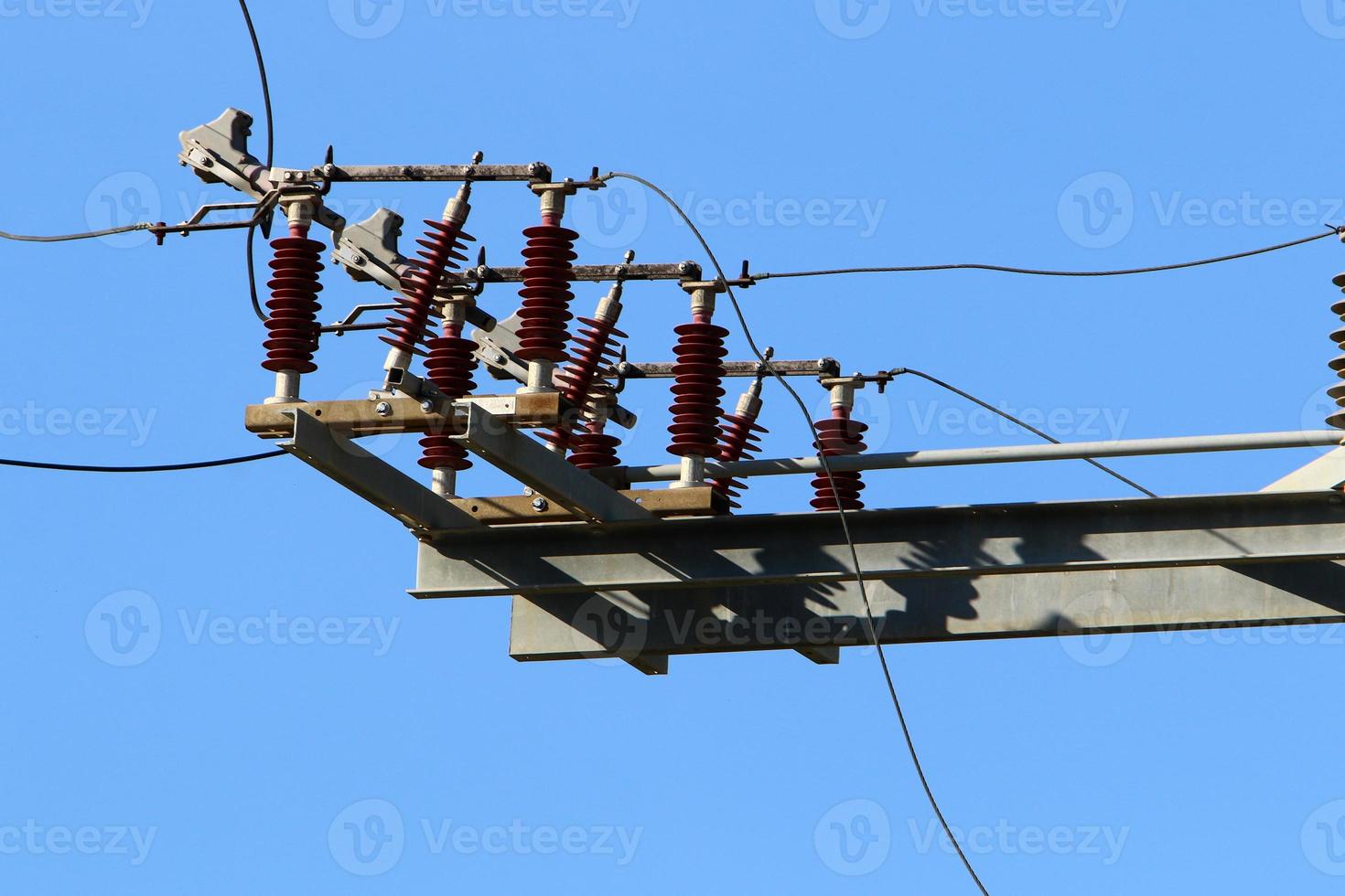 Wires on a pole carrying high voltage electric current. photo