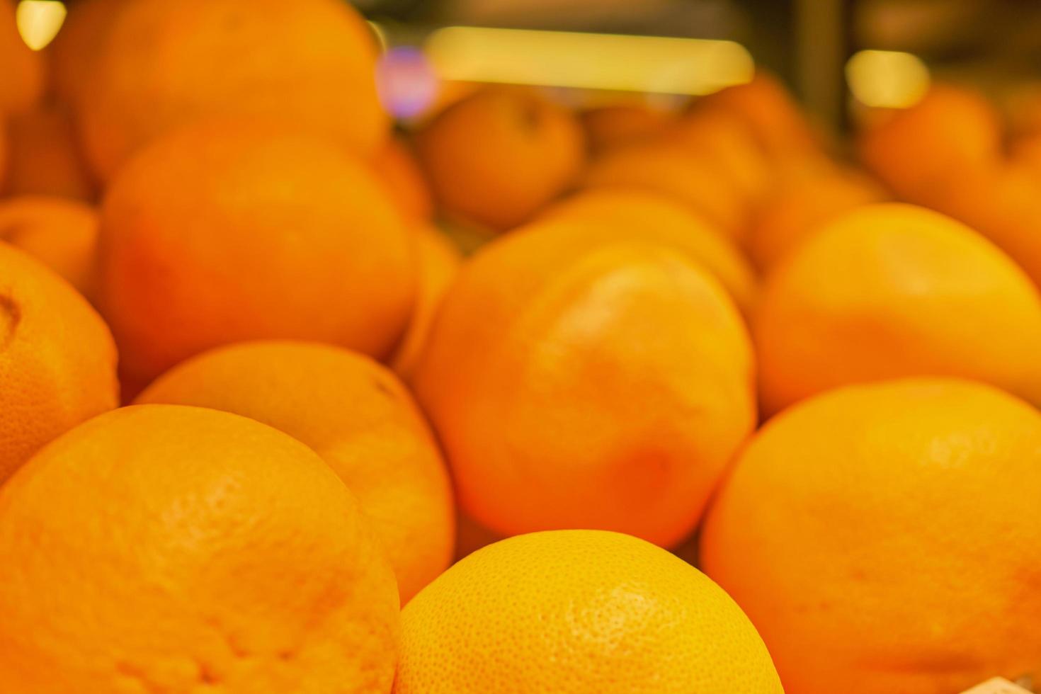 Blurred background of shelf with oranges, background and splash idea for advertising or shop photo