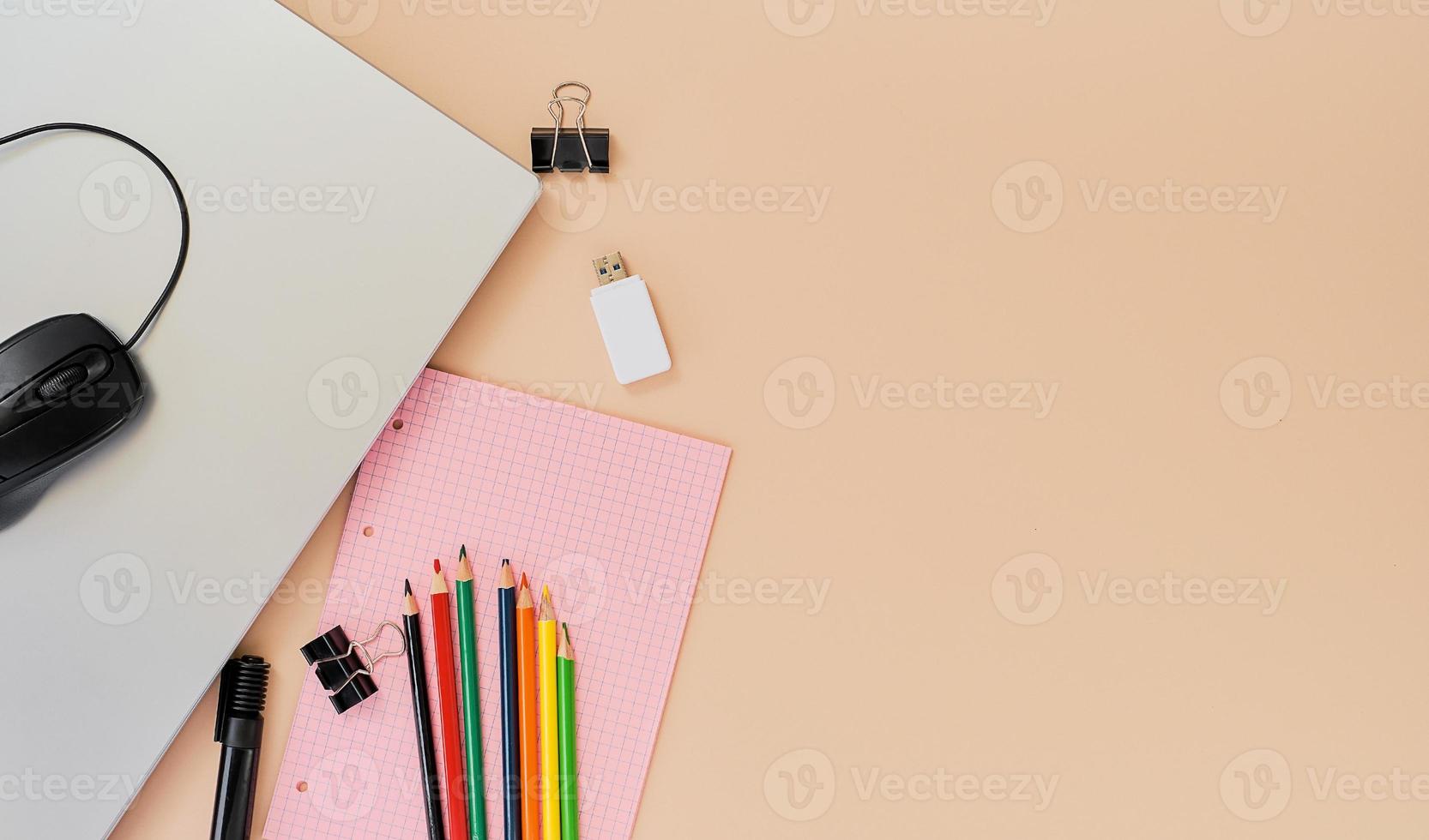 Teacher's day concept. Pencils and laptop studying digital technologies at school. Layout on nude background with copy space, idea for back to school banner. Distance learning photo