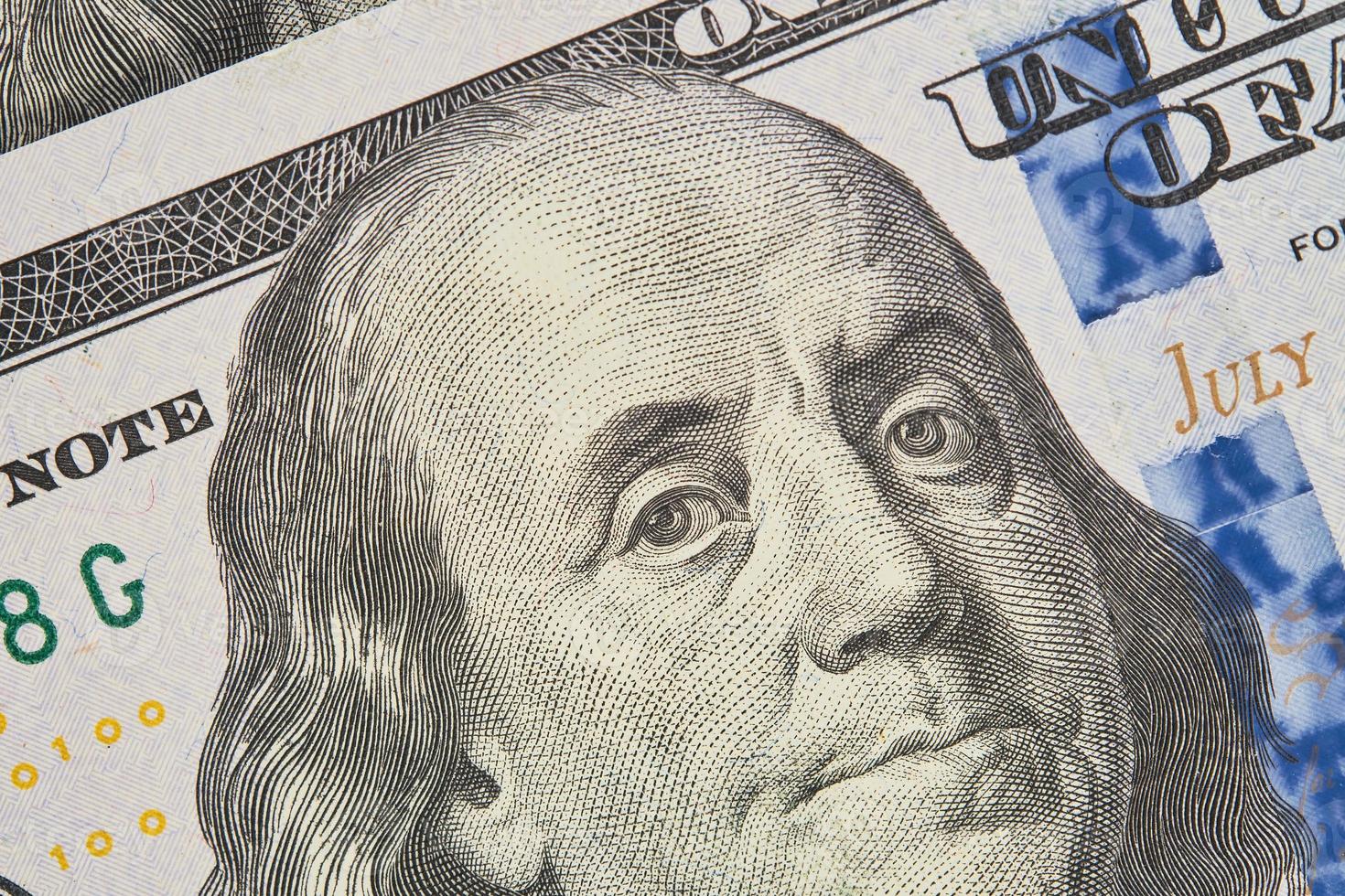 Portrait of Franklin on a hundred dollar bill. Close-up of one hundred US dollars banknotes, selective focus. Business finance concept, business news splash screen, banner mockup photo