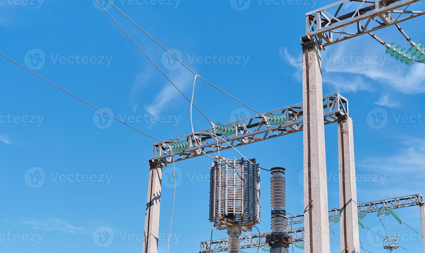 Power lines and switchgear and high voltage equipment in front of the power plant. Safe power supply. Bright sunny day, close-up. photo