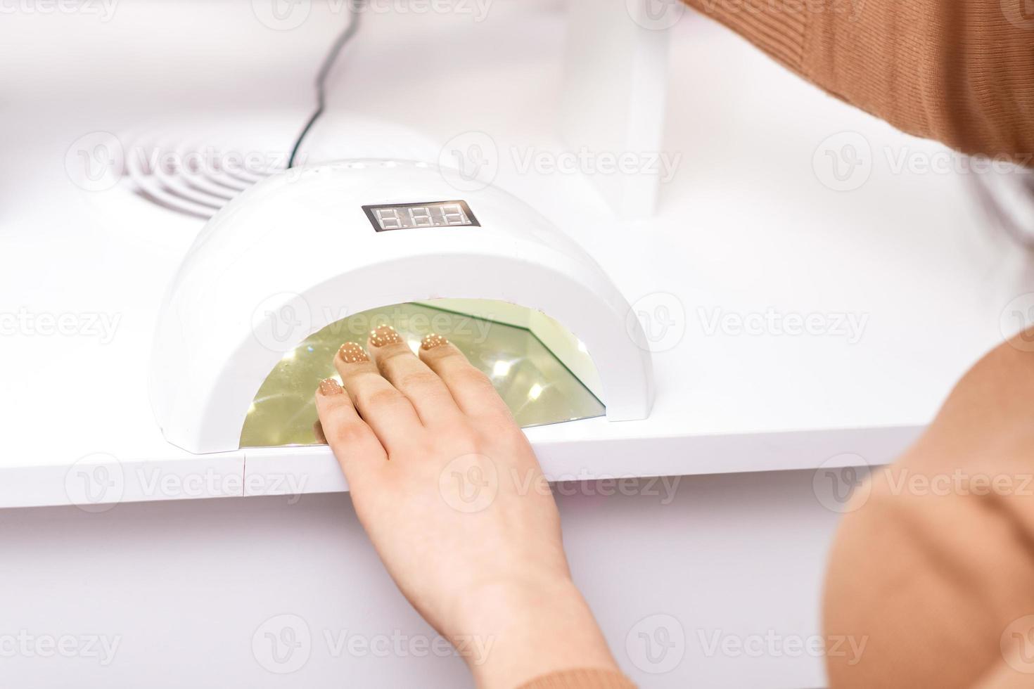 Process for drying of nails with UV lamp machine photo
