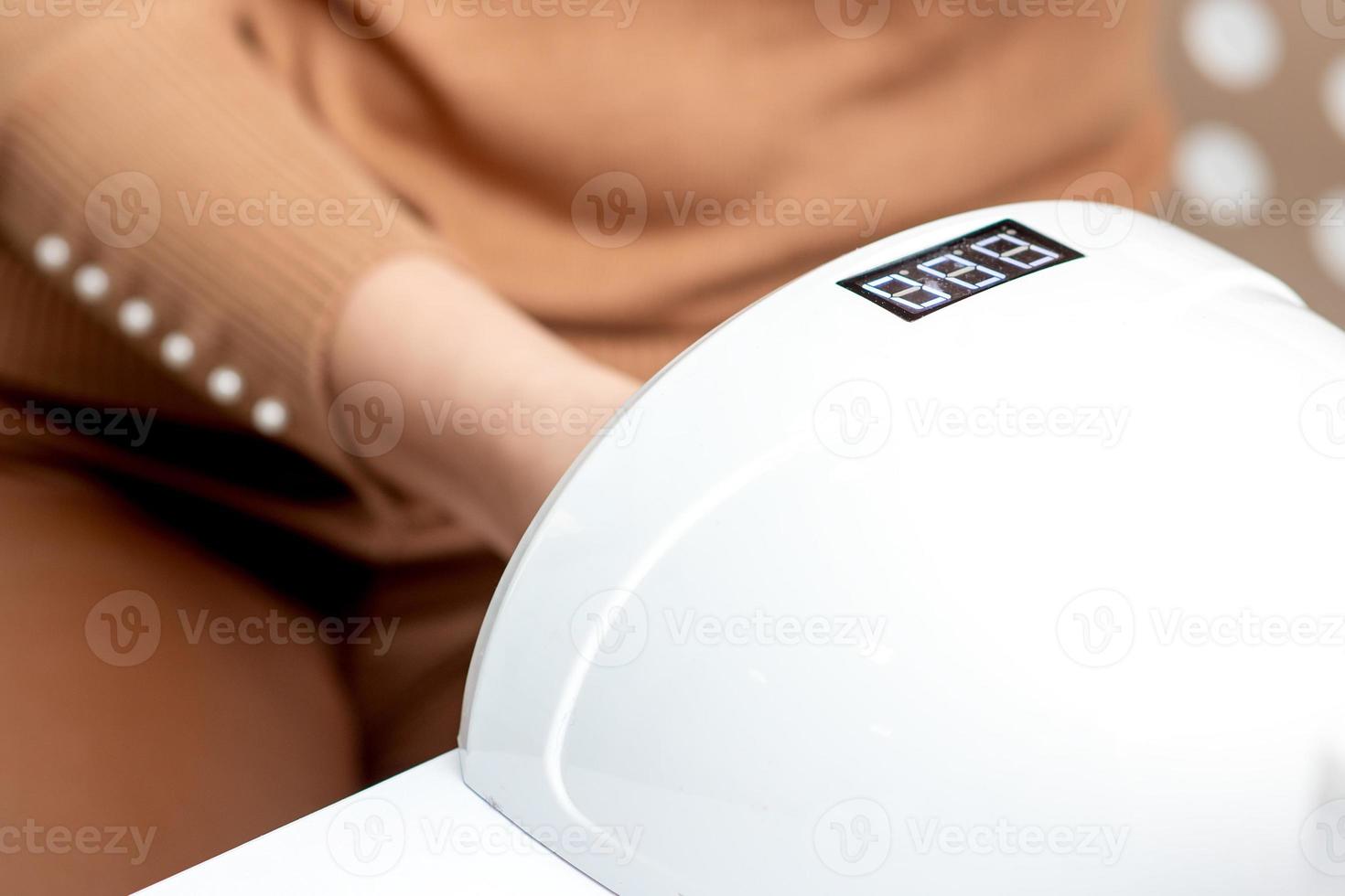 Process for drying of nails with UV lamp machine photo