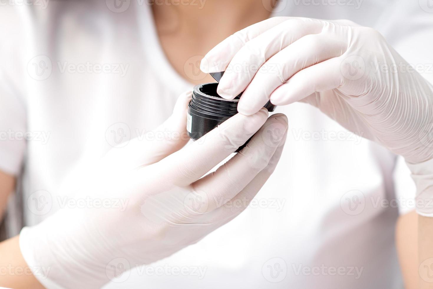 Beautician or manicure master with cosmetics or manicures product photo