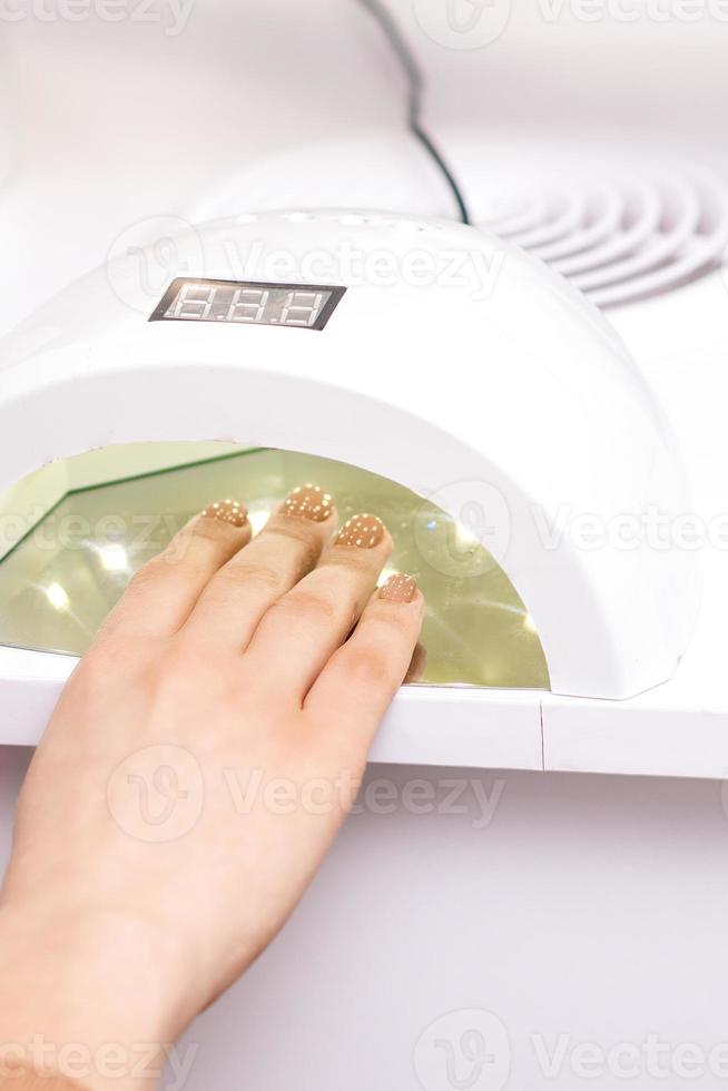 Process for drying of nails with UV lamp machine photo
