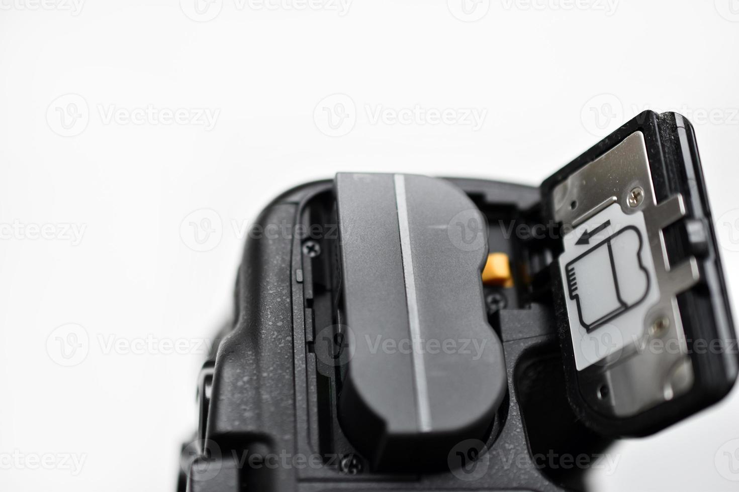 The battery of the SLR camera. Changing the camera battery in close-up. The camera battery is in the photographer's hand. photo
