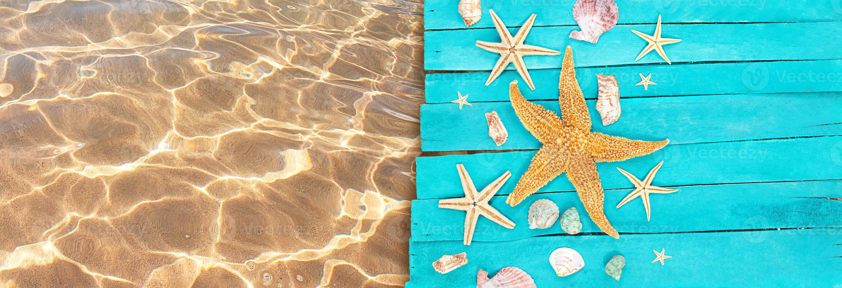 Wooden blue sea decking, boards with orange and white starfish, seashells near pool. Concept of vacation, tourism, summer. Copy space photo